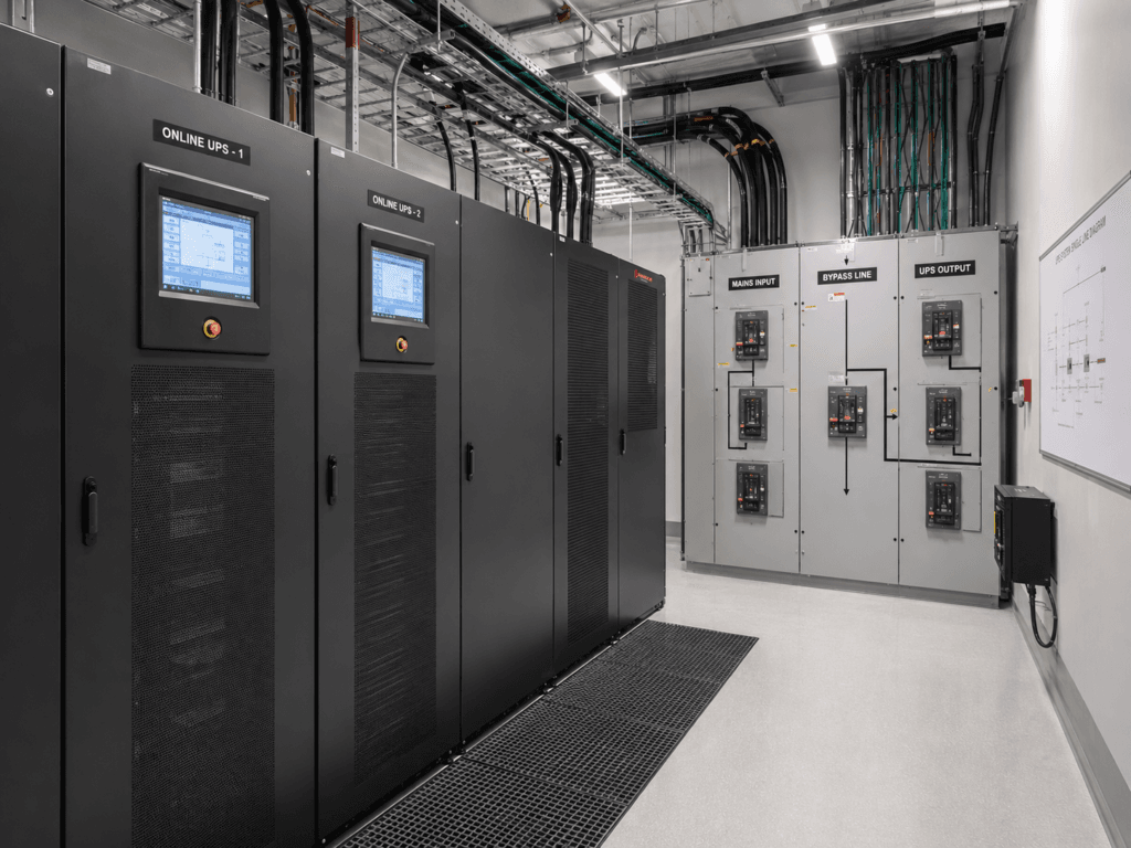 Online UPS cabinets installed beside mains input, bypass line, and UPS output switchgear in a critical power room.